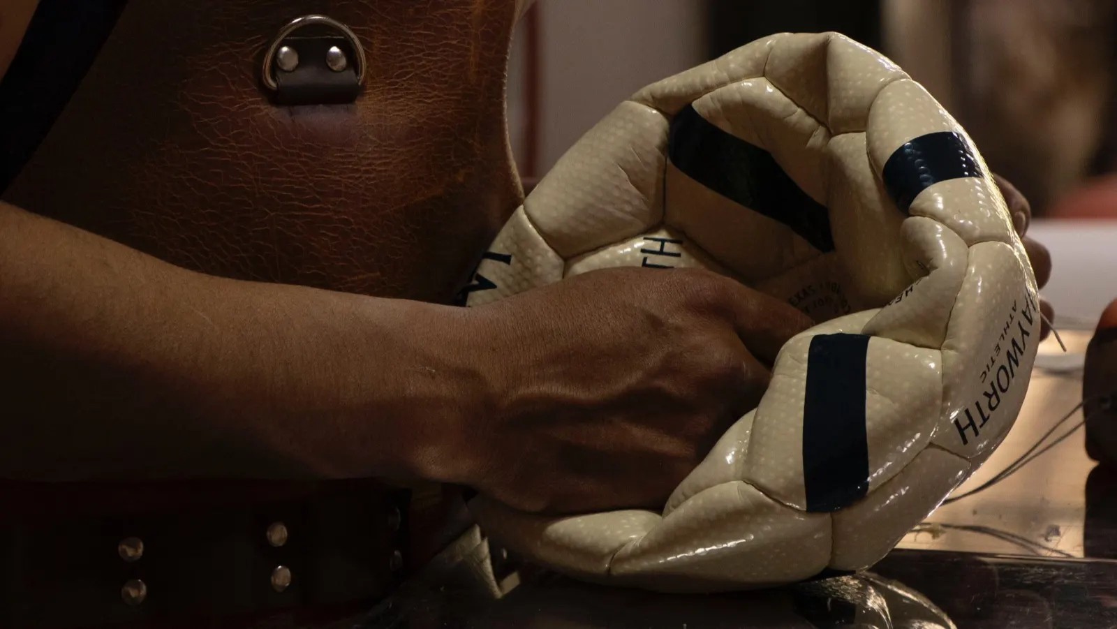 Artisan hand-stitching a Hayworth Athletic soccer ball in the Andean workshop